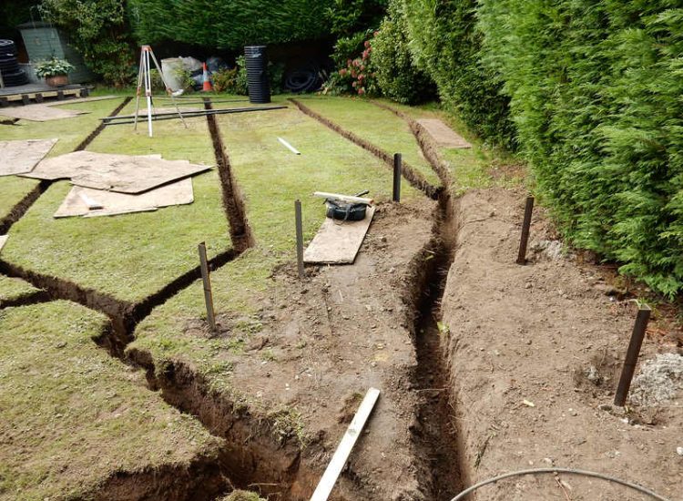 Garden and Lawn Drainage Esher, Surrey - Land drainage was installed here leading to a sump and pump to help with the issues of the clay soil type lawn. Other works included hardwood sleeper raised planting borders and driveway drainage. Garden drainage - MDB Landscapes