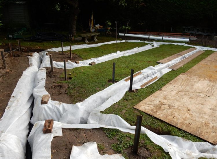 Garden and Lawn Drainage Esher, Surrey - Land drainage was installed here leading to a sump and pump to help with the issues of the clay soil type lawn. Other works included hardwood sleeper raised planting borders and driveway drainage. Garden drainage - MDB Landscapes
