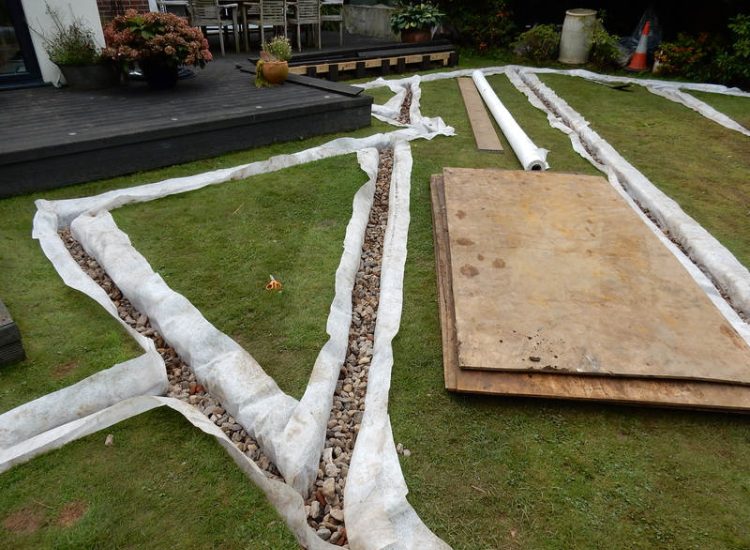 Garden and Lawn Drainage Esher, Surrey - Land drainage was installed here leading to a sump and pump to help with the issues of the clay soil type lawn. Other works included hardwood sleeper raised planting borders and driveway drainage. Garden drainage - MDB Landscapes