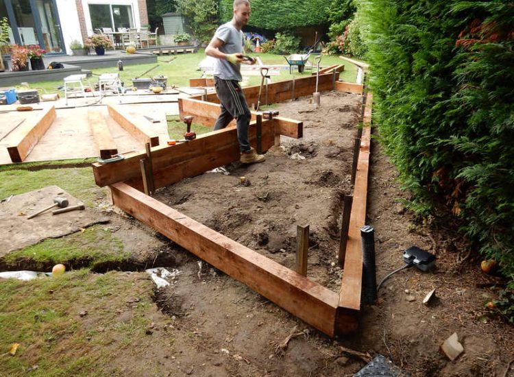 Garden and Lawn Drainage Esher, Surrey - Land drainage was installed here leading to a sump and pump to help with the issues of the clay soil type lawn. Other works included hardwood sleeper raised planting borders and driveway drainage. Garden drainage - MDB Landscapes