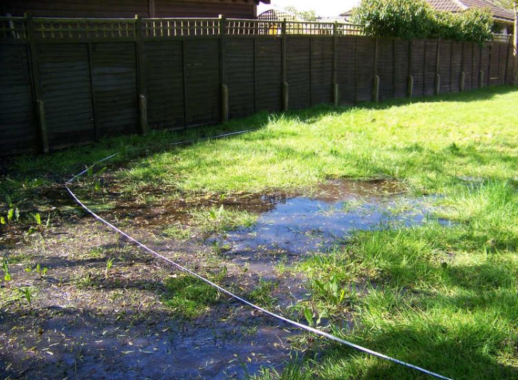 Lawn Drainage Crondall, Hampshire - Land drains, a drainage layer, raising of levels and a new lawn were required for this project to change what was an unusable front garden during both winter and summer months. Garden Drainage - MDB Landscapes