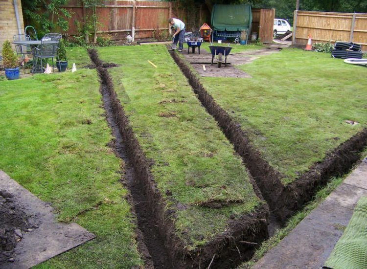 Lawn Drainage Woking, Surrey - After heavy rainfall this lawn remained water logged and unusable. Proposed land drains were installed to great effect, helping to disperse water rapidly and preventing in ground flow from higher ground. Garden Drainage - MDB Landscapes