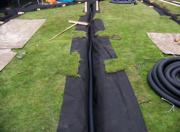 Lawn Drainage Woking, Surrey - After heavy rainfall this lawn remained water logged and unusable. Proposed land drains were installed to great effect, helping to disperse water rapidly and preventing in ground flow from higher ground. Garden Drainage - MDB Landscapes