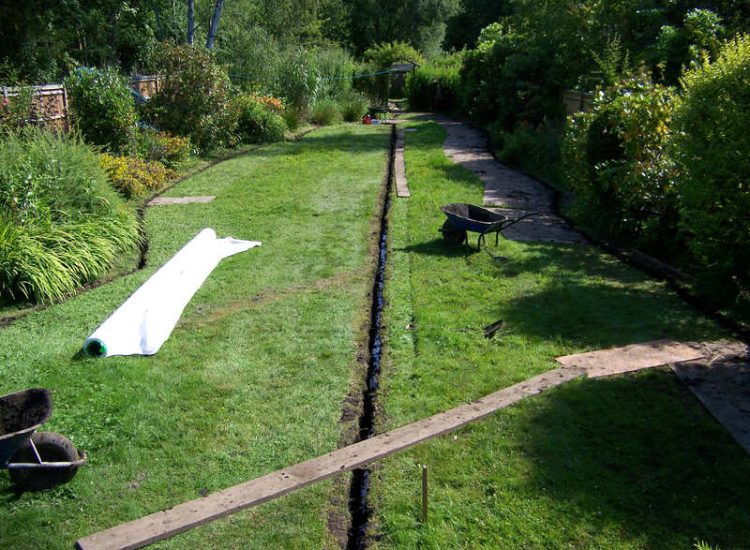 Garden and Lawn Drainage Wormley, Godalming, Surrey - With a very moisture retentive soil type and a constant in ground flow of water this garden remained unusable through out the whole year for the entire family. Garden Drainage - MDB Landscapes
