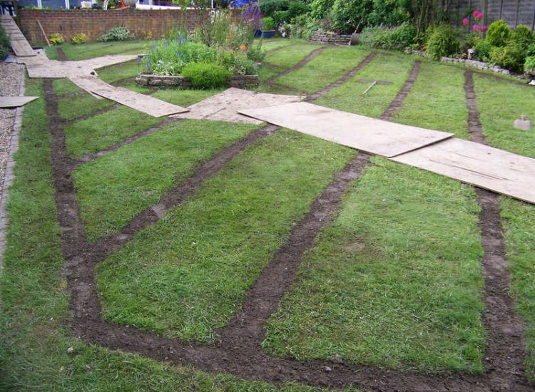 Lawn Drainage Wrecclesham, Farnham, Surrey - A constant in ground flow of water and poor water retentive soil type left the majority of this rear lawn wet and boggy. Extensive land drains were proposed and installed to great effect. The lower area of the garden was used as a discharge point for the drained water collecting first into a water reservoir. Garden Drainage - MDB Landscapes