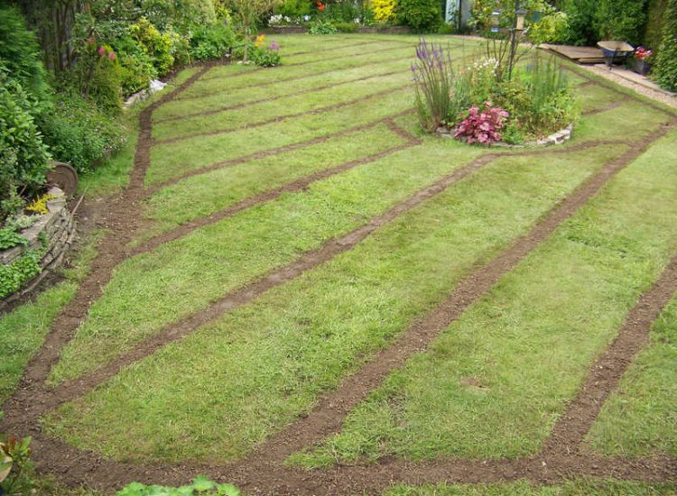 Lawn Drainage Wrecclesham, Farnham, Surrey - A constant in ground flow of water and poor water retentive soil type left the majority of this rear lawn wet and boggy. Extensive land drains were proposed and installed to great effect. The lower area of the garden was used as a discharge point for the drained water collecting first into a water reservoir. Garden Drainage - MDB Landscapes
