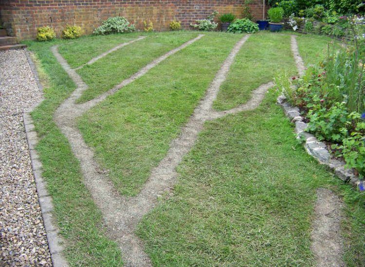 Lawn Drainage Wrecclesham, Farnham, Surrey - A constant in ground flow of water and poor water retentive soil type left the majority of this rear lawn wet and boggy. Extensive land drains were proposed and installed to great effect. The lower area of the garden was used as a discharge point for the drained water collecting first into a water reservoir. Garden Drainage - MDB Landscapes