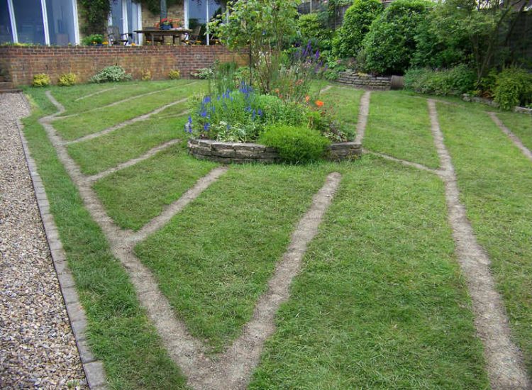 Lawn Drainage Wrecclesham, Farnham, Surrey - A constant in ground flow of water and poor water retentive soil type left the majority of this rear lawn wet and boggy. Extensive land drains were proposed and installed to great effect. The lower area of the garden was used as a discharge point for the drained water collecting first into a water reservoir. Garden Drainage - MDB Landscapes