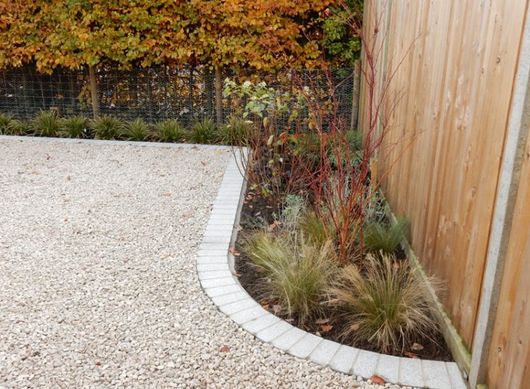 Decorative Aggregate Driveway Farnham, Surrey, GU9 - Old English limestone chippings framed with a crisp and neat edging of sawn granite setts.