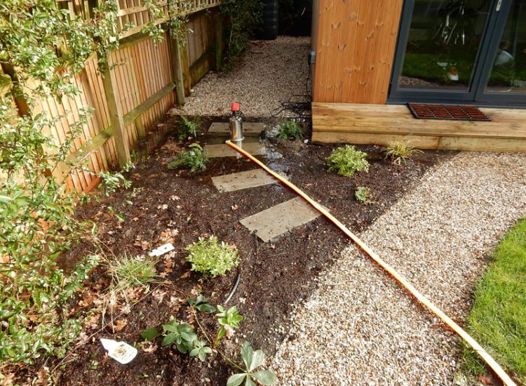 Drainage to Protect Garden Building Forest Hill, London, SE23 - A garden building installed within the lowest point of the garden with ingress from neighbouring land and the clients own garden, threatening the structure and restricting access. Drainage to Protect Garden Building Forest Hill, London, SE23 - A garden building installed within the lowest point of the garden with ingress from neighbouring land and the clients own garden, threatening the structure and restricting access.