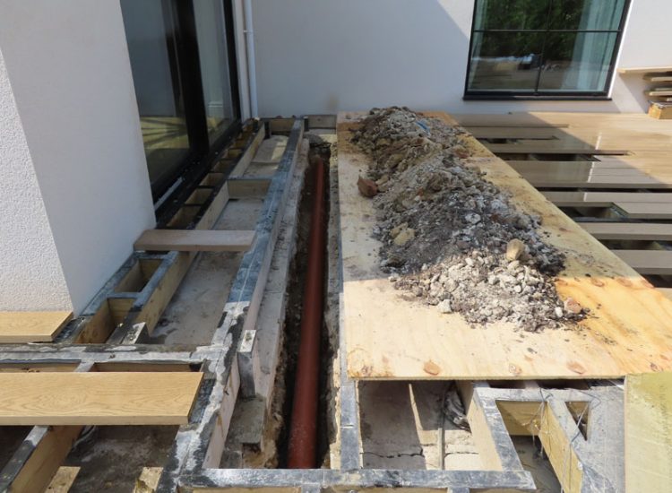 Garden and Lawn Drainage Esher, Surrey, KT10 - A previously installed drainage system which had failed to prevent flooding of lower lawn areas. Garden and Lawn Drainage Esher, Surrey, KT10 - A previously installed drainage system which had failed to prevent flooding of lower lawn areas.