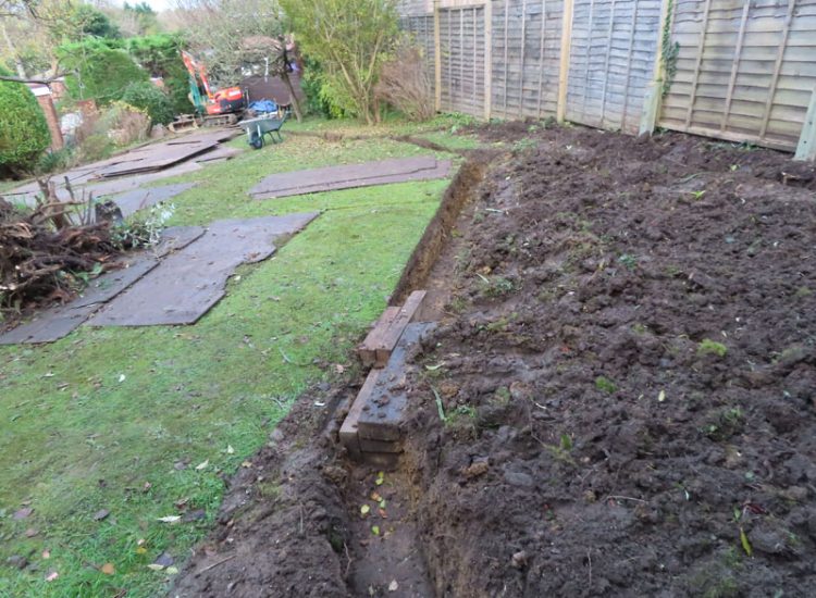 Garden and Lawn Drainage Guildford, Surrey, GU1 - Ingress from neighbouring higher ground caused by tree removal and alterations to levels, leading to flooding around the house. Garden and Lawn Drainage Guildford, Surrey, GU1 - Ingress from neighbouring higher ground caused by tree removal and alterations to levels, leading to flooding around the house.