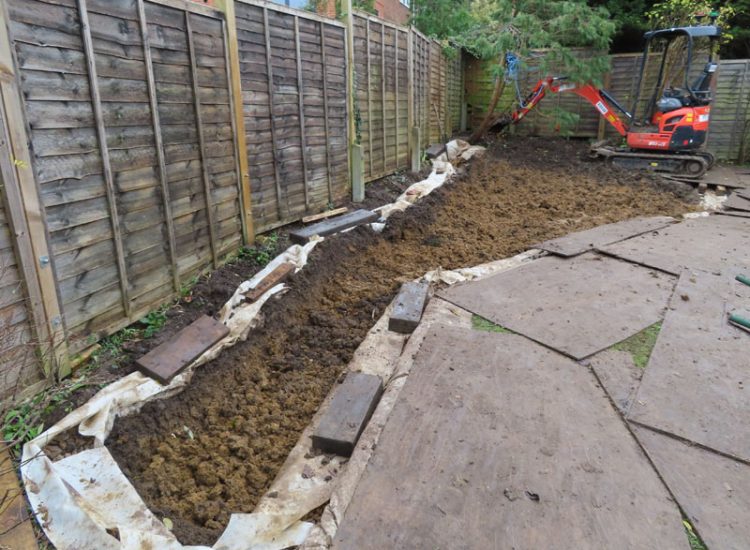 Garden and Lawn Drainage Guildford, Surrey, GU1 - Ingress from neighbouring higher ground caused by tree removal and alterations to levels, leading to flooding around the house. Garden and Lawn Drainage Guildford, Surrey, GU1 - Ingress from neighbouring higher ground caused by tree removal and alterations to levels, leading to flooding around the house.