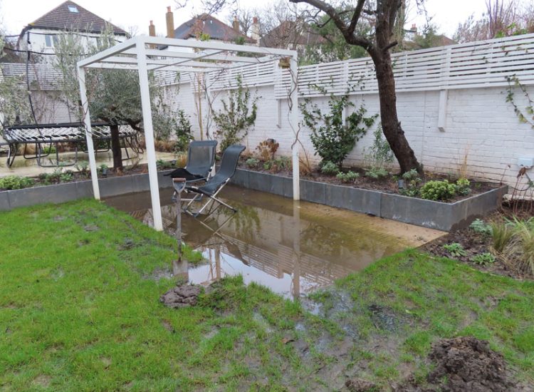 Lawn and Garden Drainage Raynes Park, London, SW20 - Failed drainage solutions needing to be resolved in a recently completed landscaped rear garden. Lawn and Garden Drainage Raynes Park, London, SW20 - Failed drainage solutions needing to be resolved in a recently completed landscaped rear garden.