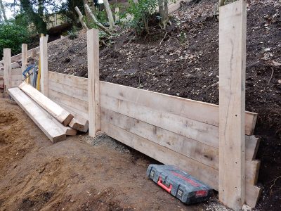New Oak Sleeper Retaining Walls Farnham, Surrey, GU9 - Extensive oak sleeper retaining walls within an embankment area. New Oak Sleeper Retaining Walls Farnham, Surrey, GU9 - Extensive oak sleeper retaining walls within an embankment area.