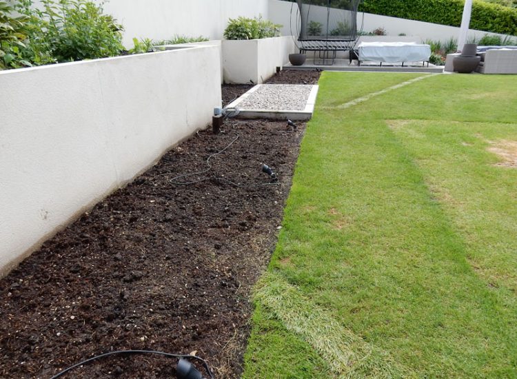 Garden and Planting Border Drainage Cobham, Surrey, KT11 - High retaining walls constructed with no drainage detail behind.