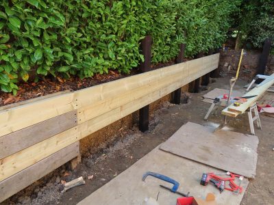 Timber Retaining Walling Claygate, Surrey, KT10 - Repair and replacement of sections of old, dilapidated timber walling. Timber Retaining Walling Claygate, Surrey, KT10 - Repair and replacement of sections of old, dilapidated timber walling.