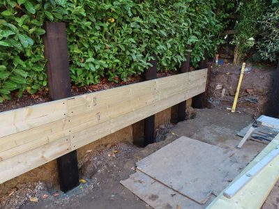 Timber Retaining Walling Claygate, Surrey, KT10 - Repair and replacement of sections of old, dilapidated timber walling. Timber Retaining Walling Claygate, Surrey, KT10 - Repair and replacement of sections of old, dilapidated timber walling.