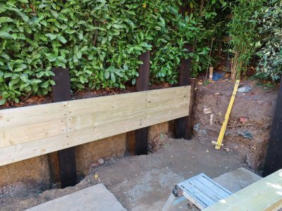 Timber Retaining Walling Claygate, Surrey, KT10 - Repair and replacement of sections of old, dilapidated timber walling. Timber Retaining Walling Claygate, Surrey, KT10 - Repair and replacement of sections of old, dilapidated timber walling.